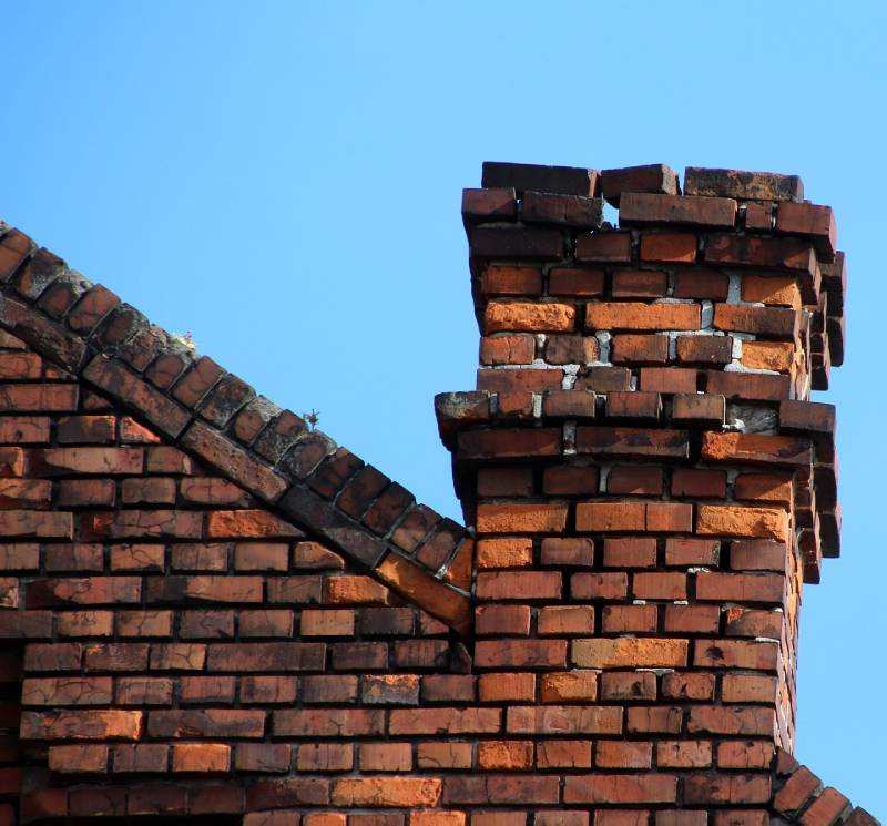 Signs Your Seal Beach Home Needs a Chimney Inspection Damaged chimney on an Seal Beach home showing cracks and missing mortar